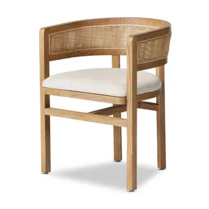 Barrel-back dining armchair in natural parawood with crosshatch cane back panel and off-white seat cushion