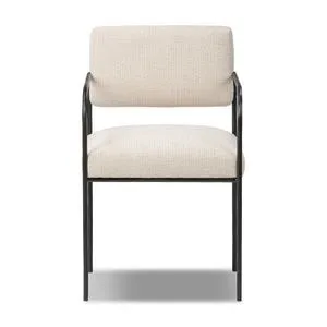 Fenn Dining Chair with slim hammered black iron frame, squared cream-colored upholstered seat and bolster back