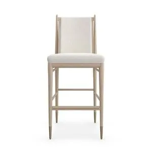 Unity Light bar stool with ivory boucle fabric seat and back, sun drenched oak frame, and lucent bronze metal ferrules