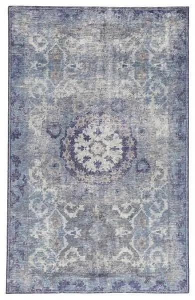 Top-down view displaying full vintage medallion pattern and cool-toned color variation of rug.