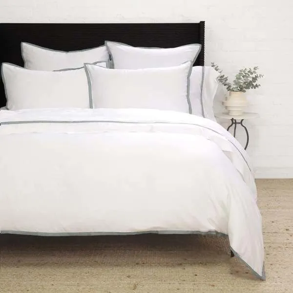 Twin-sized Langston Bamboo Sateen Duvet Set in ocean blue with smooth fabric and subtle border trim on a bed