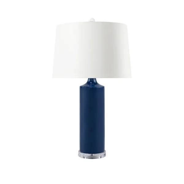 Conniston Lamp with navy blue glazed ceramic column, curved neck, clear round base, and white drum shade