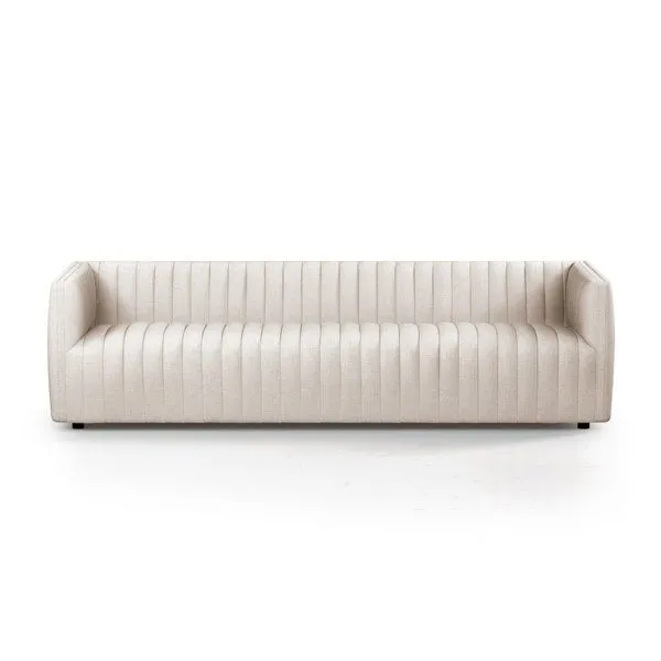 Cream-colored version of Augustine Sofa angled against white background with vertical channeling