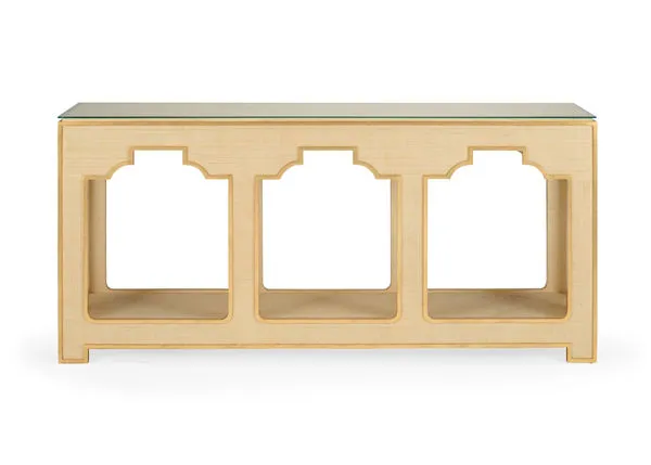 Cream colored raffia console table with gold accents and a clear tempered glass top, rectangular shape
