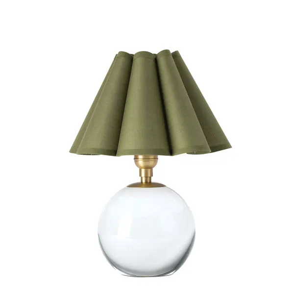 Compact table lamp with a white spherical base and green scalloped fabric shade with natural brass hardware