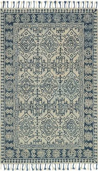 Zharah Mist Blue Rug with bold blue and cream geometric patterns and fringed edges, 100% wool pile