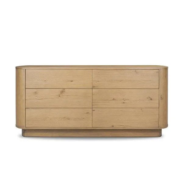 Six-drawer dresser in light worn oak with rounded edges and pedestal base