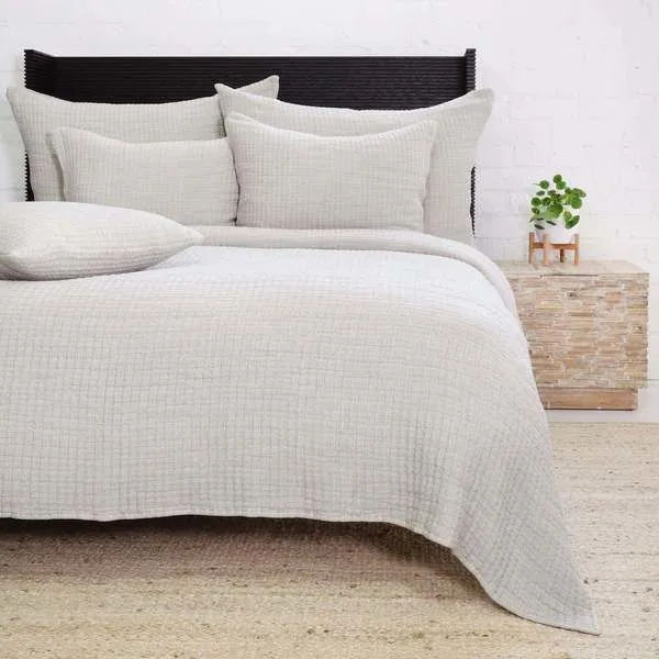 Grey Vancouver Coverlet on king bed with matching pillows and textured weave