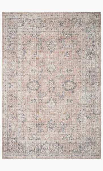 Full rug laid flat on white background showing blush and grey faded floral design