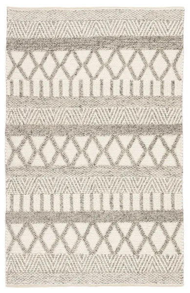 Rectangular handmade rug with gray and white tribal-inspired geometric patterns in Scandinavian wool design