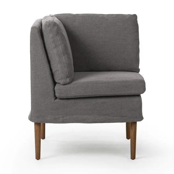 Cozy corner dining banquette in broadway denim flax linen with amber oak legs, clean lines, and plush cushions