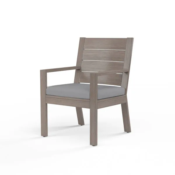 Laguna Dining Chair with driftwood-finished aluminum frame and gray cushion, slatted back and armrests