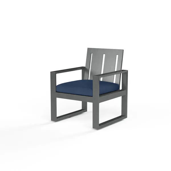 Redondo Dining Chair with wide slat back, linear slate-finished aluminum frame, and blue cushioned seat