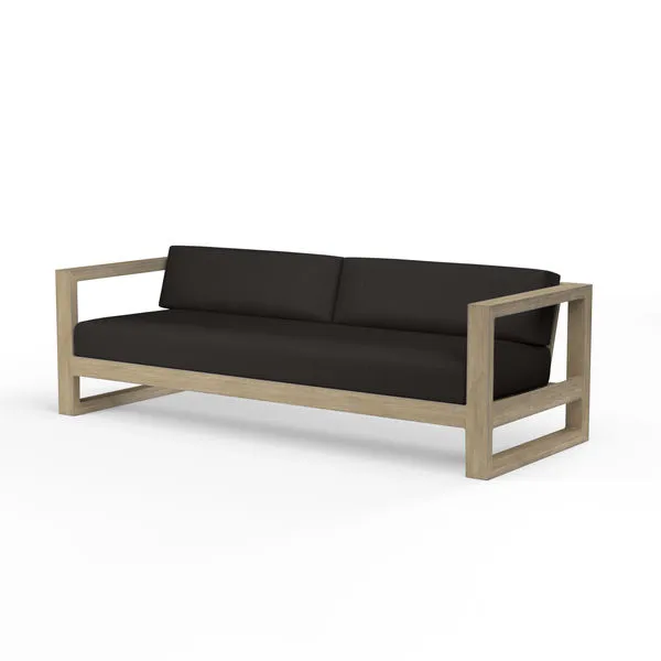 Coastal Teak Sofa with deep seating, solid teak wood frame in warm grey finish and dark charcoal cushions