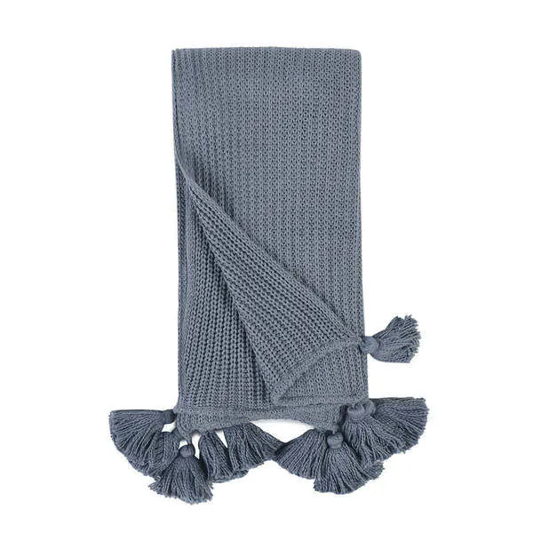 Kerith 50x70 inch blue 100% cotton throw blanket with oversized tassels and classic knit design folded