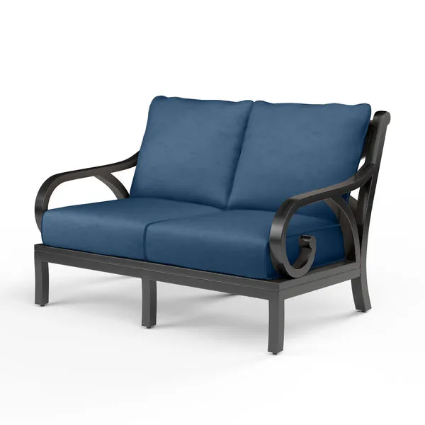 Monterey Loveseat with dark espresso aluminum frame and deep blue outdoor cushions with curved armrests