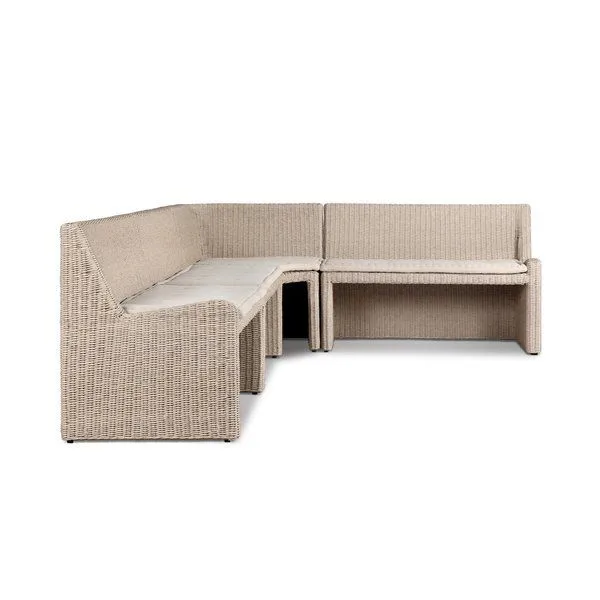 Antique-inspired L-shaped outdoor dining banquette in natural rattan with fabric cushion