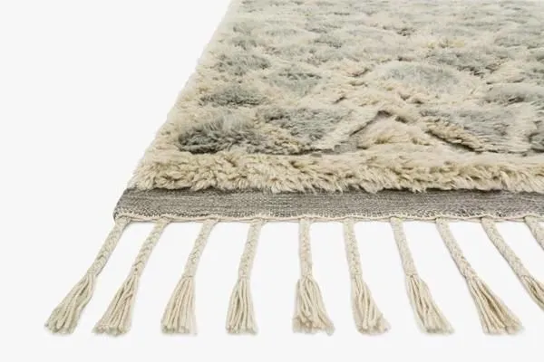 Taupe shag rug with hand-knotted wool texture and Scandinavian-inspired geometric pattern with fringed edges