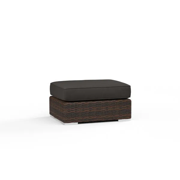 Montecito Ottoman with rich Cognac multi-colored resin wicker base and dark cushion for outdoor use