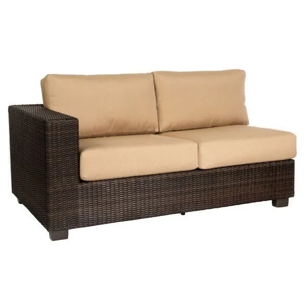 Dark brown wicker outdoor sectional sofa with beige cushions and wide armrest on left side