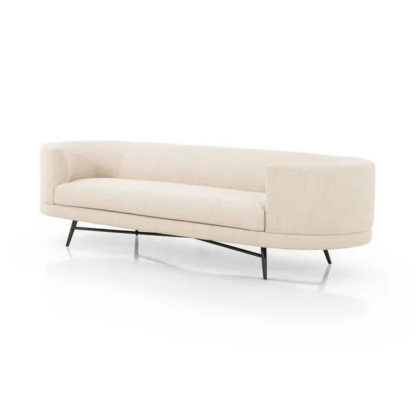 Ivory taupe upholstered sofa with soft pillowing, curved arms, black stainless steel splayed legs and cross-base stretchers
