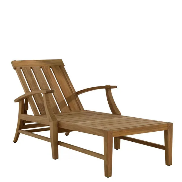 Croquet teak chaise lounge in natural wood finish with slatted seat and back and curved armrests.