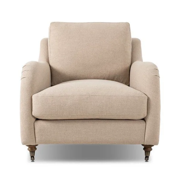 Lynne Chair with rolled arms, sink-in cushions, turned wood legs with casters, upholstered in soft beige linen-cotton blend
