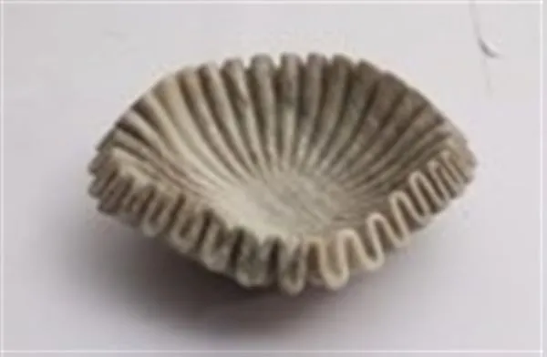 Brown marble bowl with natural veining and a unique ruffled edge design