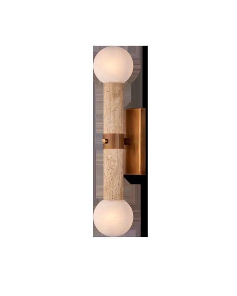 Beatrix Bath Wall Sconce with vertical travertine column, antique brass mounting, and two milky textured art glass globes