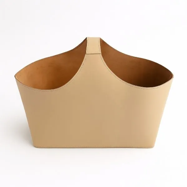 Beige Napa single handle bucket with smooth exterior and suede-like interior in a minimalist trapezoidal shape