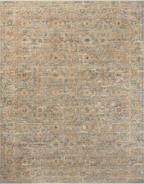Vintage-inspired Heritage Ocean Sand rug with intricate faded motifs in beige, blue, and tan hues