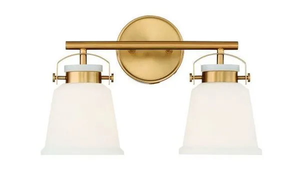 Kaden 2 Light Bath fixture with warm brass finish and frosted white glass shades in contemporary style
