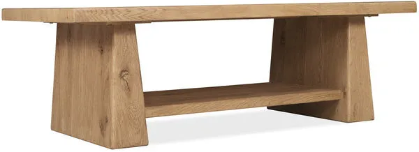 Rectangular cocktail table in warm Buckboard oak finish with double pedestal base and fixed lower shelf