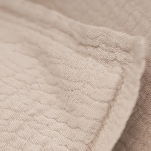 Macro close-up of wavy pebbled texture and soft cotton fabric on Waverly duvet set