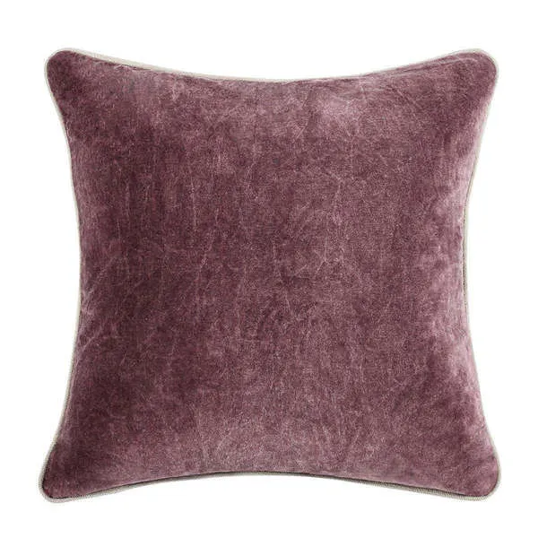 Square throw pillow in dusty mauve velvet with soft antique wash and outlined in light beige piping