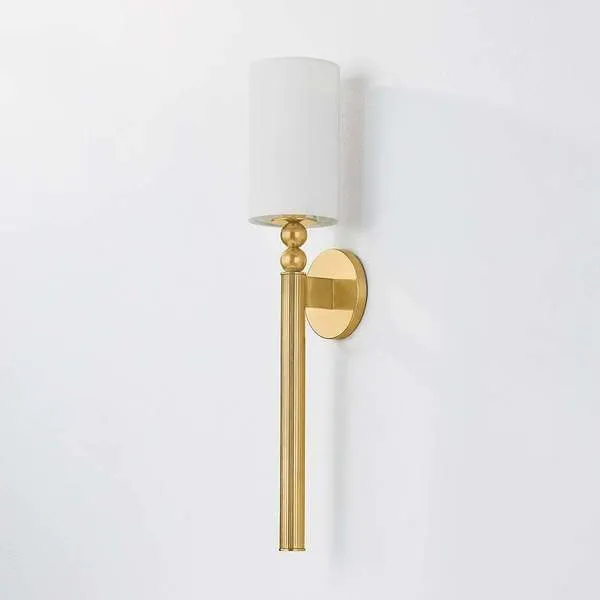 Lakeport Wall Sconce in Aged Brass with vertically fluted tail, stacked decorative spheres, and white cylindrical shade