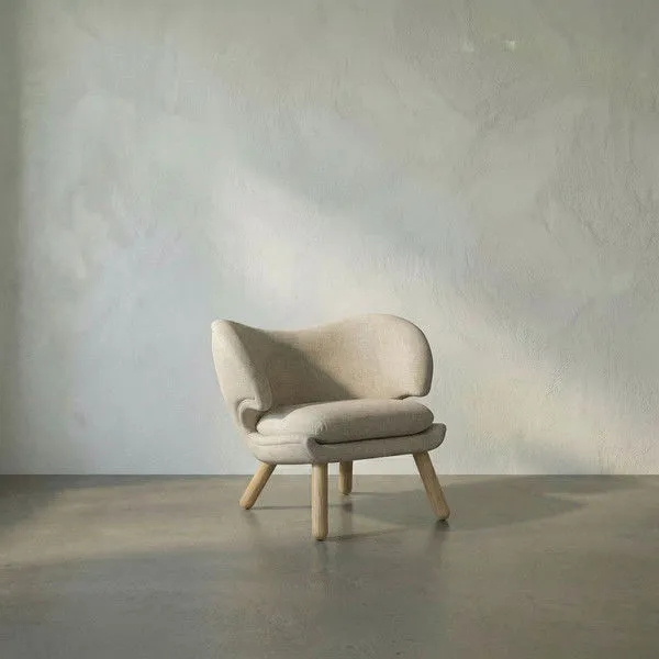 Valerie Chair with curved Ocean Grey fabric back, plush seat cushion, and angled Sungkai/Mindi wood legs in Charcoal Black...
