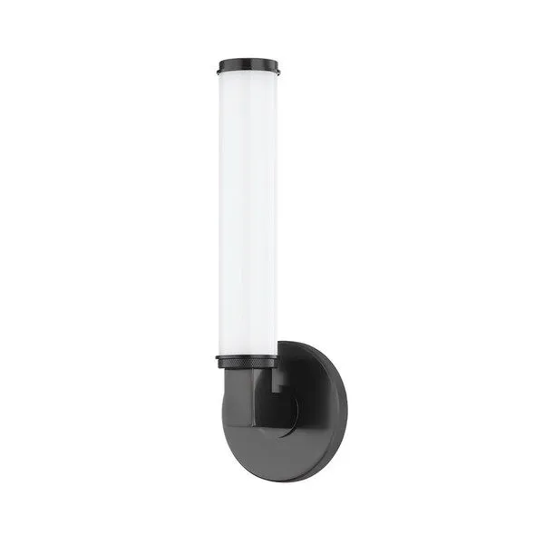 Old bronze wall sconce with round backplate, thick rectangular arm, and cylindrical opal glass shade with knurled metal ends