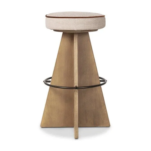 Damon swivel stool with a geometric wooden base, circular metal footrest, and round beige upholstered seat with brown piping