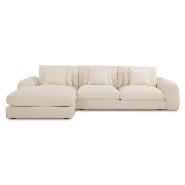 Berga sectional sofa with soft cream fabric, plush cushions, and relaxed pillow-like design with chaise on left