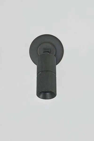Directional wall sconce with circular backplate, mechanical hinge, and knurled 2-inch cylinder in distressed bronze