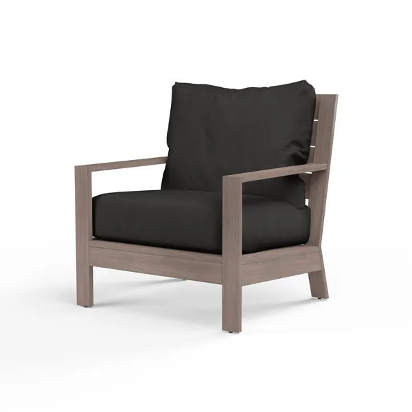 Laguna Club Chair with hand-brushed aluminum frame mimicking driftwood and thick black cushions