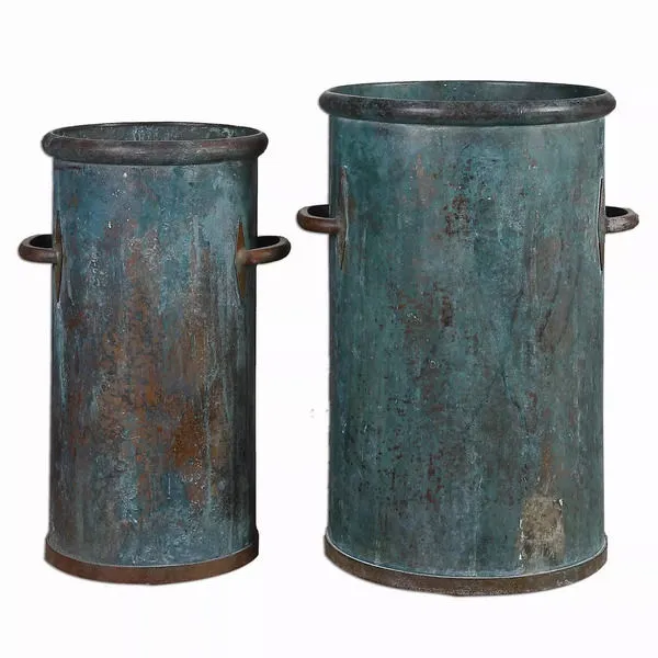 Two tarnished copper cans showing a darker patina with a plain white background