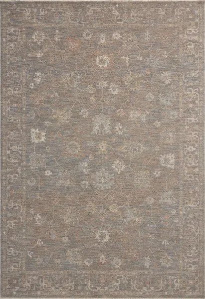 Traditional Turkish-inspired rug in pale blue, cream, and brown tones with intricate faded floral patterns