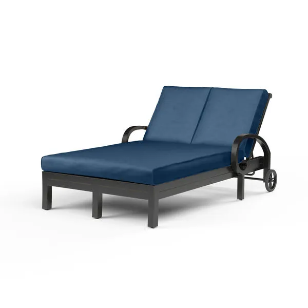 Monterey Double Chaise with navy cushions and aluminum frame featuring curled arm and cross back detail