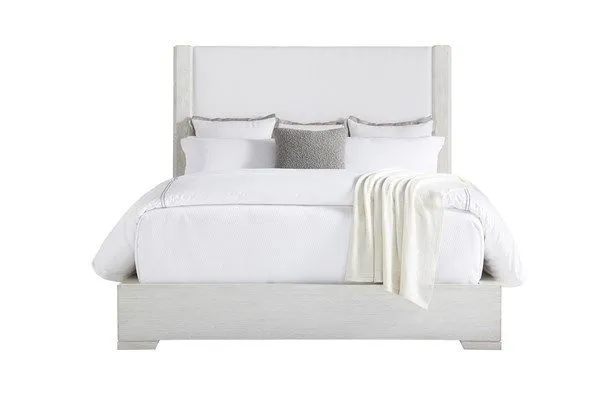 Ridge Queen Upholstered Bed with high padded fabric headboard framed by weathered wood, white bedding, and throw