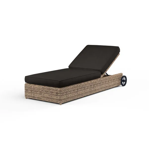 Havana Adjustable Chaise in weathered tobacco wicker with black cushioned upholstery and adjustable backrest, side view