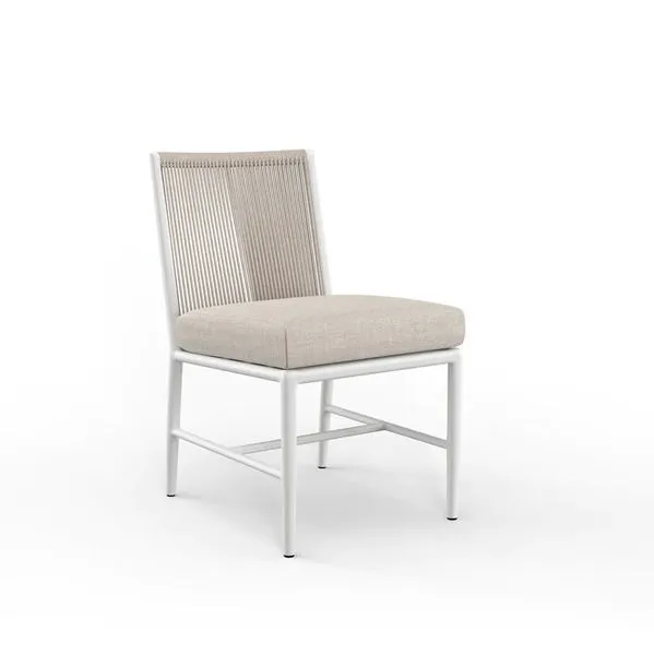 Sabbia Armless Dining Chair with satin white aluminum frame, natural colored all-weather rope back, and beige cushioned seat