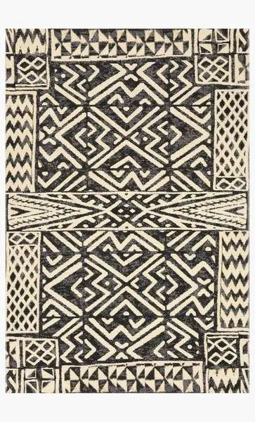 Overhead view of rectangular ivory and black rug displaying full tribal-inspired geometric pattern
