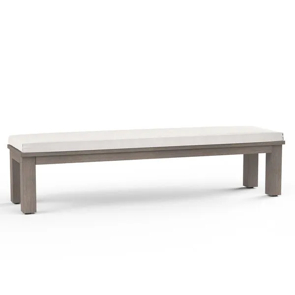 Laguna Dining Bench with hand-brushed driftwood finish aluminum frame and a tailored plank seat with light beige cushion